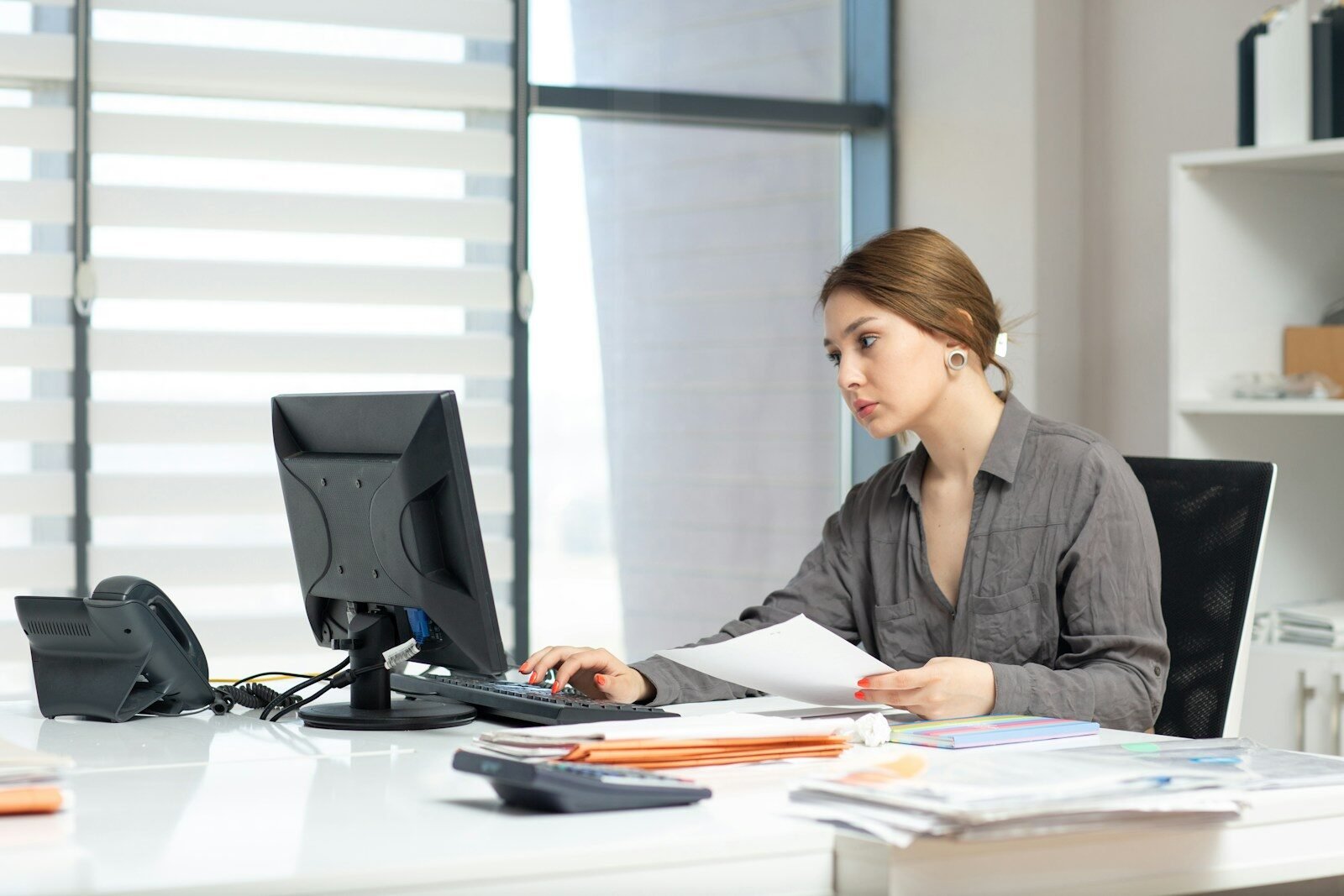 a woman sitting at a table with a laptop